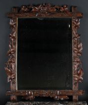 A Black Forest rectangular looking glass, carved with fruiting vine, bevelled mirror plate, 75cm