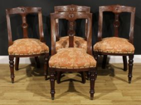 A set of four late Victorian walnut gondola form dining chairs, each curved cresting rail carved