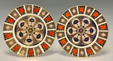 A pair of Royal Crown Derby Imari palette 1128 pattern dinner plates, 27cm diameter, one first one