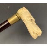 A contemporary carved bone handled walking stick, the handle as the head of a dog, 84cm long