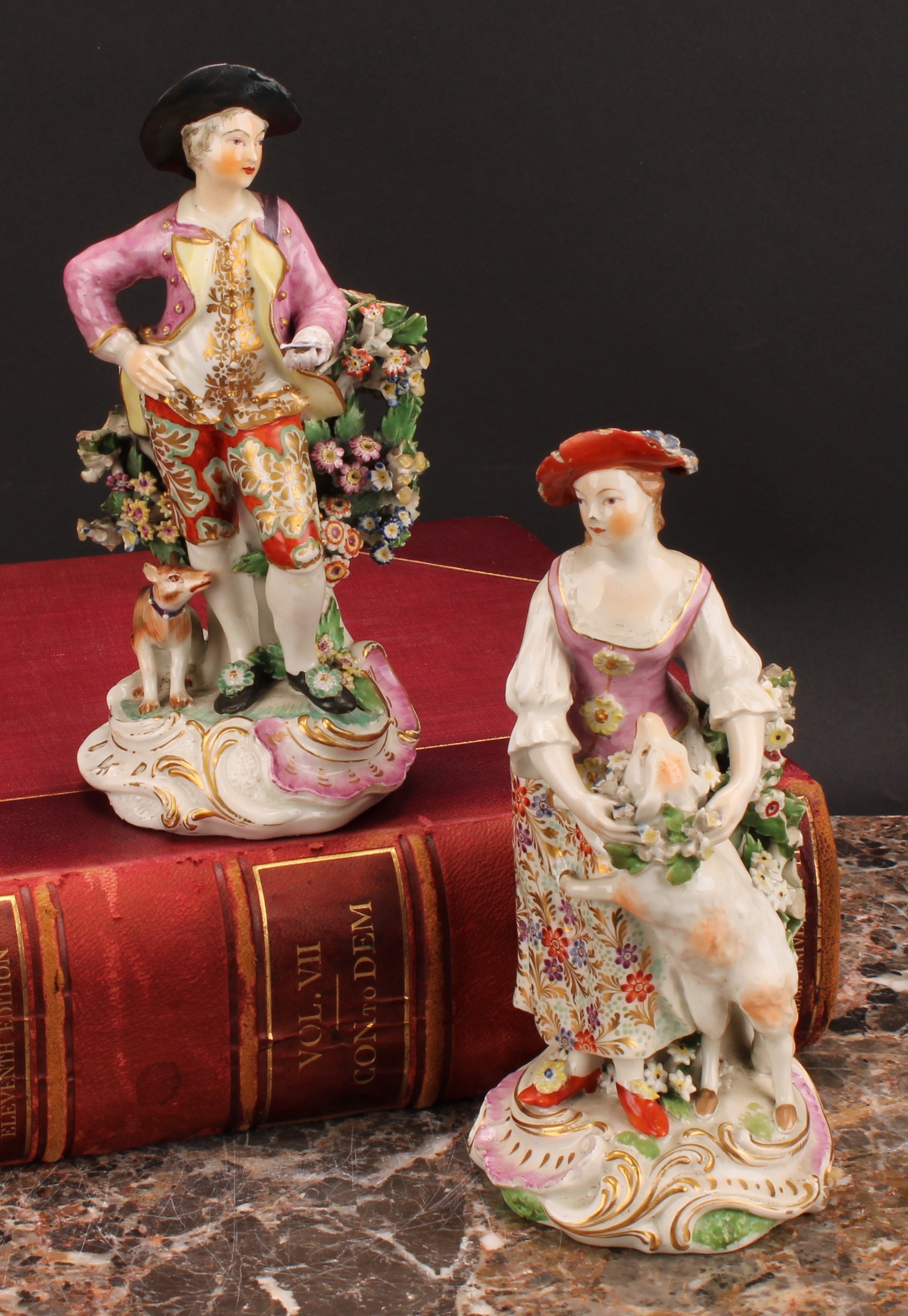 A pair of Derby figures, The Garland Shepherds, he wearing a broad brimmed black hat, pink jacket,