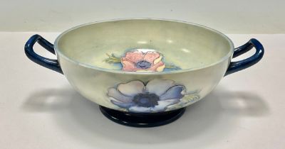 A Moorcroft Poppy pattern two handled pedestal dish, in muted shades of pink, green and mottled