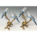 A pair of Continental style porcelain and faux ormolu candleholders, each mounted with a pair of