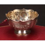 A Chinese silver lotus shaped pedestal bowl, applied with panels of chrysanthemums, bamboo, irises