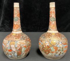 A pair of Japanese export ware Satsuma bottle vases, typically decorated with figures and