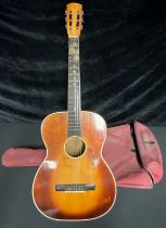 An acoustic guitar, soft case