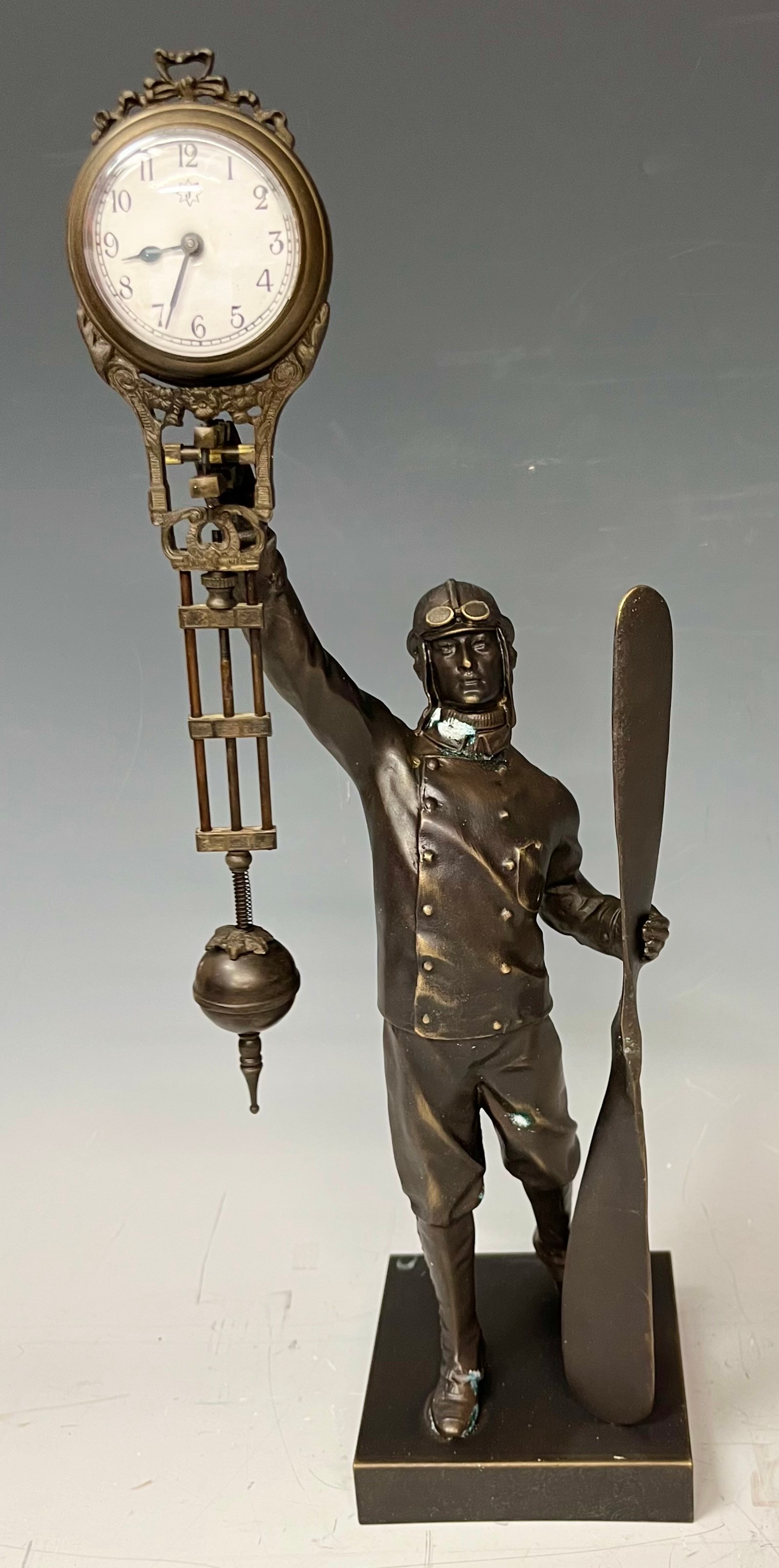 A bronzed metal mystery clock modelled as an aviator, approx. 38.5cm high