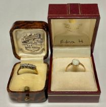 An 18ct gold five stone diamond ring, size N/O, 2.4g, boxed; a 9ct gold ring, set with a polished