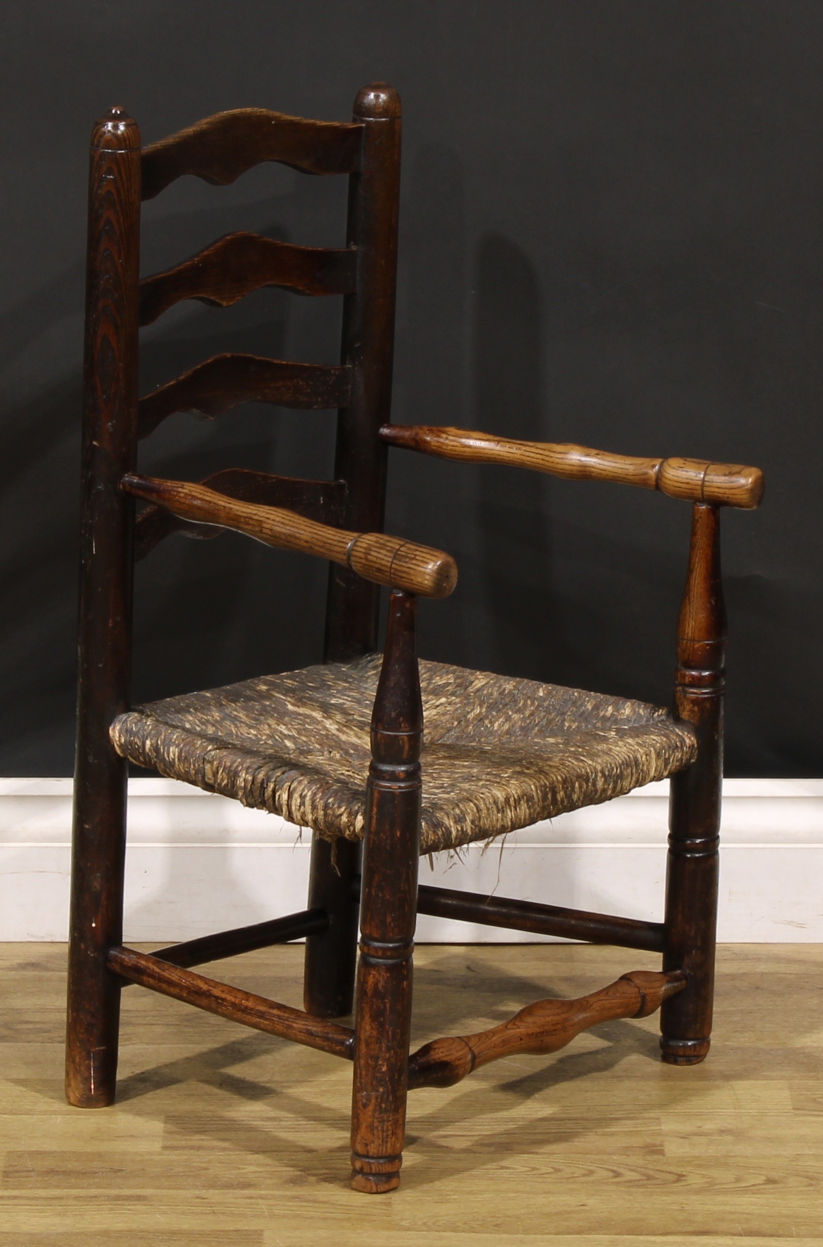 A 19th century elm child's chair, shaped ladder back, turned arms, legs and stretchers, rush seat, - Image 2 of 4