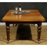 A Victorian walnut and mahogany extending dining table, rounded rectangular top with one