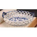 An early Derby two-handled oval basket, central oval reserve painted in underglaze blue with a