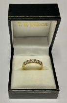 An 18k gold five stone diamond ring, size O, Birmingham 2005, 3.7g, boxed