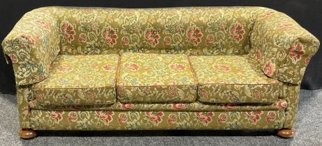 An early 20th century country house Chesterfield sofa, stuffed-over upholstery, squab cushions,