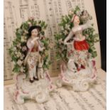 A pair of Derby patch mark figures, Shepherd and Shepherdess, he standing playing a horn with a