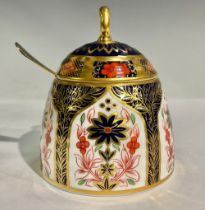 A Royal Crown Derby 1128 Old Imari pattern honey jar and cover, solid gold band, 11cm high, first