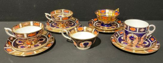 A Royal Crown Derby 1128 Imari pattern trio, c.1934; an associated pair of 1128 Imari trios; another