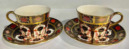 A pair of Royal Crown Derby 1128 Old Imari pattern teacups and saucers, solid gold band, first