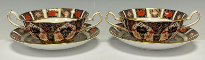 A pair Royal Crown Derby Imari palette 1128 pattern two handled soup dishes on stands, second