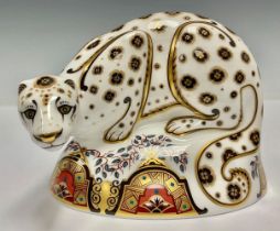 A Royal Crown Derby paperweight, Snow Leopard, gold stopper, 15cm wide, printed mark in red