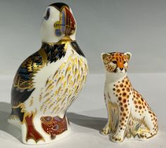 A Royal Crown Derby paperweight, Puffin, gold stopper; another, Cheetah Cub, gold stopper (2)