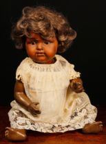 An Armand & Marseille (Germany) bisque head and painted composition black doll, the painted bisque