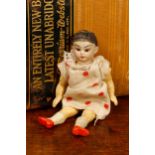 A bisque head and composition bodied miniature Oriental doll, probably by Simon & Halbig (