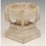 A 19th century Italian marble font, of small proportions, in the Grand Tour manner, flanked by