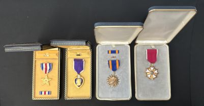 Collection of four United States Medals in presentation cases to include: Purple Heart complete with