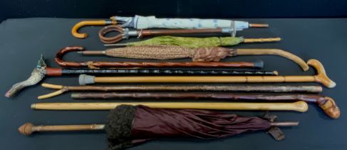 An early 20th century parasol, carved treen handle, others later, umbrellas, walking sticks,