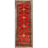 A North-west Persian Senneh Runner carpet, central row of nine diamond-shaped medallions, within a