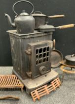 A Coalbrookdale cast iron wood burner stove, along with a cast iron kettle, three lidded pans, two