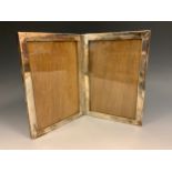 A silver diptych double photograph frame, marked Sterling