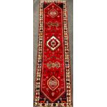 A South-west Persian Qashgai runner carpet, hand-knotted in rich colours, with five medallions,