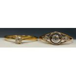 An Art Deco diamond ring, old brilliant cut target collar set principle diamond flanked by lozenge