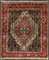 A North West Persian Senneh rug / carpet, hand-knotted with a central diamond-shaped medallion, in