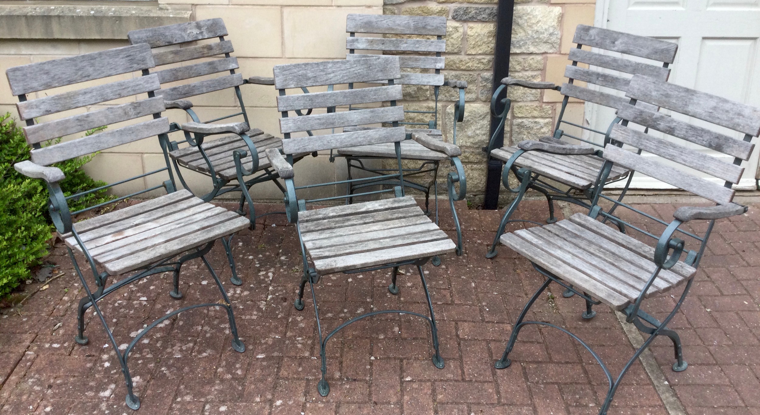 Garden Furniture - a set of six wrought iron framed slatted wooden folding garden chairs, each