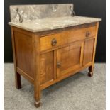 An Arts and Crafts period oak washstand, the marble top with wrought iron brackets, c.1910