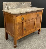 An Arts and Crafts period oak washstand, the marble top with wrought iron brackets, c.1910