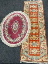 A Milas Seccade Yolluk wool runner, approx 288cm x 84cm; a Chinese oval rug, approx 150cm x 91cm (2)