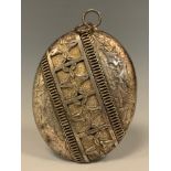 A large 19th century Aesthetic Movement silver coloured metal oval locket, embossed and relief