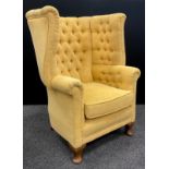 A Queen Anne revival deep wing-back armchair, with button-back and sides, cabriole legs, 105cm