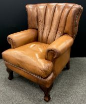 A tan leather ‘Tetrad Blake’ type, ‘Barrel-back’ armchair, 101cm high x 83cm wide x 91cm deep.