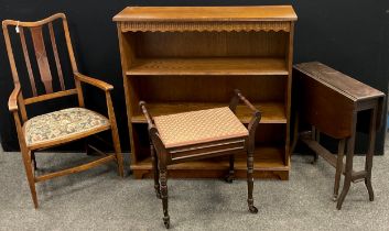 An Edwardian beech and walnut armchair; oak three tier open bookcase; piano seat; drop-leaf