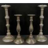 A pair of silver coloured classical candlesticks, multi knop stems, floral circular foot, 47cm high,