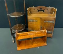 An Arts & Craft Oak two door smoker cabinet, pierced top with Heart and scroll apertures, brass
