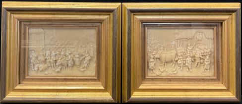 A pair of lava cameo panels, depicting genre scenes in the manner of Teniers, framed