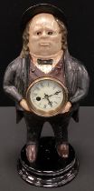 A cast iron novelty mantel clock, cast as John Bull, automaton eyes, 41cm high