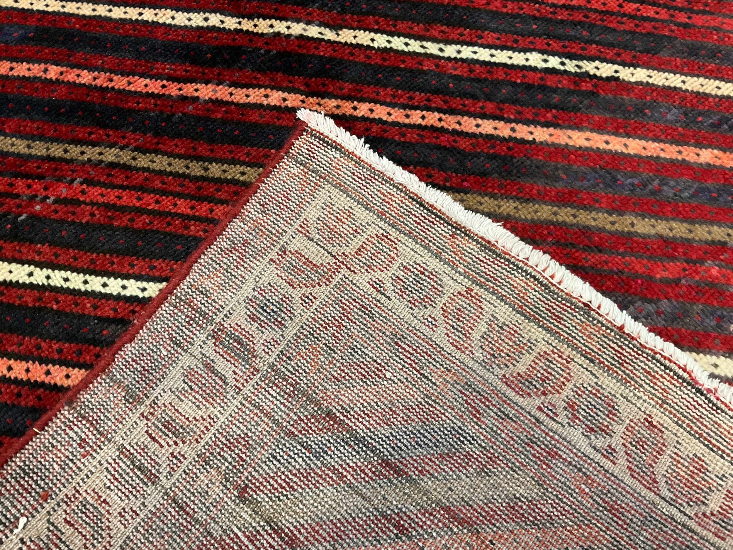 A South-west Persian Lori rug / carpet, hand-knotted, in tones of red, pink, deep indigo, and cream, - Image 2 of 2