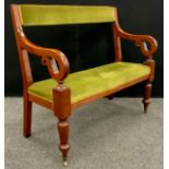 A Victorian mahogany settle, upholstered back and seat, scroll arms, turned legs, with brass casters