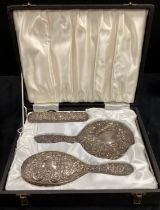 An Elizabeth II silver three piece dressing table set, Birmingham 1972, cased.